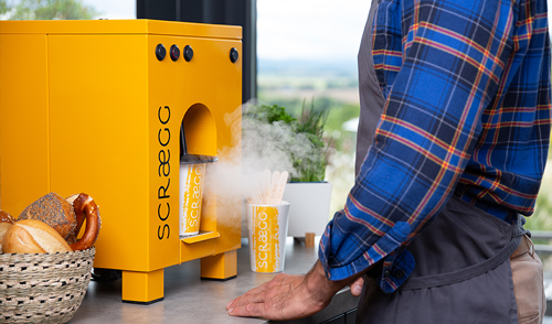 A customer using the Scraegg machine to prepare food