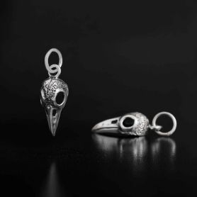 Sterling Silver Small Raven Skull Charm  on dark background