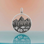 Sterling Silver Mountain Pendant with Flowers on orange background