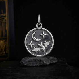 Sterling Silver Flying Bat Charm with Moon and Star on dark background