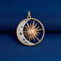 Bronze Openwork Sun with Silver Crescent Moon Charm on dark blue background