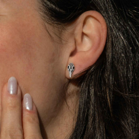 Sterling Silver Small Raven Skull Stud Earrings on ear