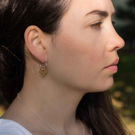 Huggie Hoops with Bronze Flower Dangle on model