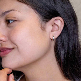 Sterling Silver Teardrop Huggie Hoop Earrings on model