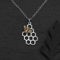 Sterling Silver Honeycomb Necklace with Bronze Bee on dark background