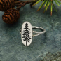 Sterling Silver Etched Pine Tree Ring on green background