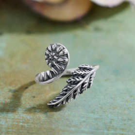 Sterling Silver Adjustable Fern Ring on green background
