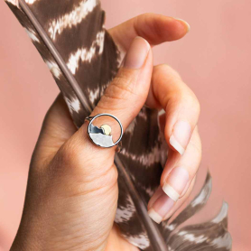 Silver Circle Layered Mountain Ring with Bronze Sun on hand