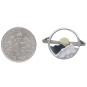 Silver Circle Layered Mountain Ring with Bronze Sun next to dime