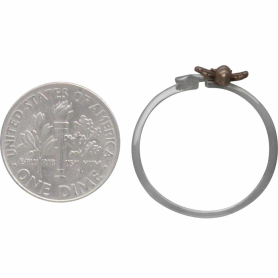 Sterling Silver Adjustable Flower and Bronze Bee Ring next to dime