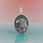 Sterling Silver Oval Dimensional Eagle Charm on pink and blue background