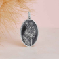 Sterling Silver Oval Dandelion Charm on pink background