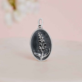 Sterling Silver Foxglove Charm on pink background