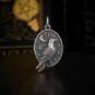 Raven Charm in Oval with Moon and Stars on dark background