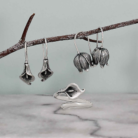 Sterling Silver Calla Lily Hook Earrings on branch with more floral silver jewelry