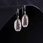 Sterling Silver Oval Pine Tree Dangle Earrings on dark background