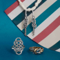 Silver and Bronze Knot Jewelry on Blue Background