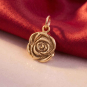 Bronze Rose Charm on red background