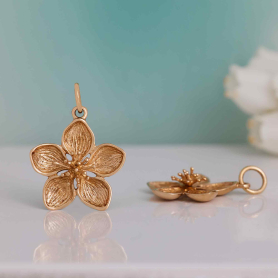 Bronze Dimensional Cherry Blossom Charm on blue background