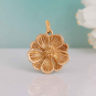 Bronze Peony Charm on blue background