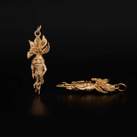 Bronze Mandrake Root Charm on dark background