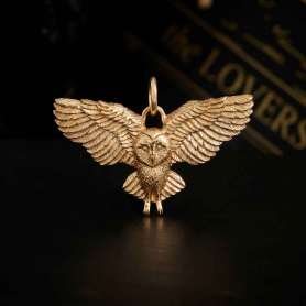Bronze Flying Owl Charm on black background