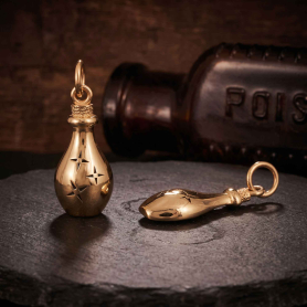 Bronze Potion Bottle Charms on dark background