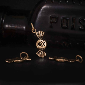 Bronze Poison Candy Charm on dark background