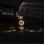Bronze Poison Candy Charm on dark background