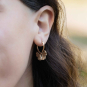 Bronze Ginkgo Leaf Huggie Hoop Earrings on ear