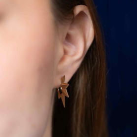 Bronze Ridged Star Huggie Hoop Earrings on ear