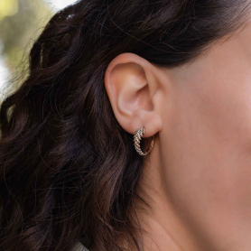 Bronze Fern Huggie Hoops on ear