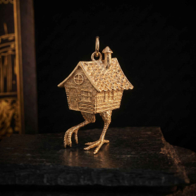 Bronze Baba Yaga House Charm on dark background
