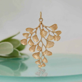 Bronze Maidenhair Fern Charm on blue background