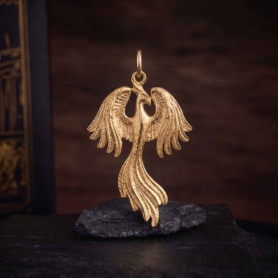 Bronze Phoenix Charm 32x19mm on dark background