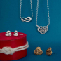 Silver and Bronze Knot Jewelry on Blue background
