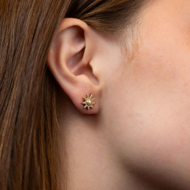 Bronze Sun Stud Earrings on ear