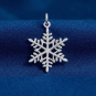 Luxe Silver Plate Snowflake Charm on blue background
