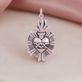 Luxe Silver Plate Flaming Sacred Heart Pendant on pink and white background