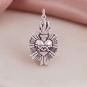 Luxe Silver Plate Flaming Sacred Heart Pendant on pink and white background