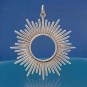 Luxe Silver Plate Spikey Sun Pendant on bluebackground