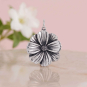 Luxe Silver Plate Cosmos Charm on pink background