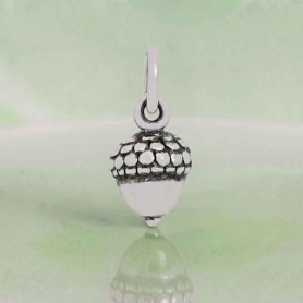 Luxe Silver Plate Acorn Charm on green background