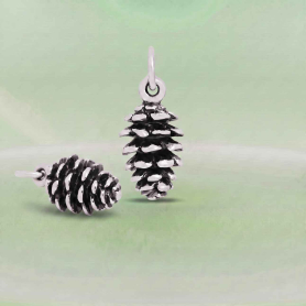 Luxe Silver Plate Pinecone Charms on green background