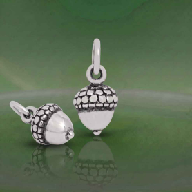 Luxe Silver Plate Acorn Charms on green background