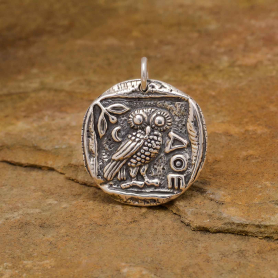 Luxe Silver Plate Ancient Owl Coin Charm on yellow background