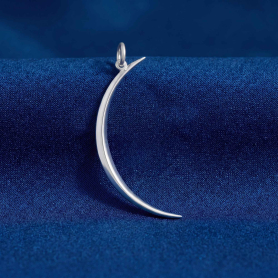 Luxe Silver Plate Skinny Crescent Moon Pendant on dark blue background