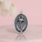 Luxe Silver Plate Iris Charm on pink background