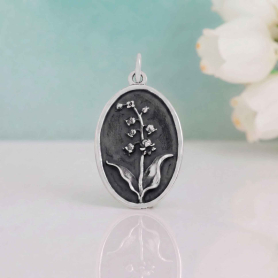 Luxe Silver Plate Lily of the Valley Charm on blue backround