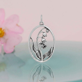 Luxe Silver Plate Lily of the Valley Charm on pink and blue background